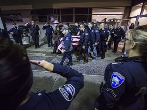 Officers and medical staff take part in a procession for officer Daniel McCartney, of Yelm, at St. Joseph Medical Center in Tacoma, Wash., on Monday, Jan. 8, 2018. The department said McCartney was responding to a home invasion in the Frederickson area, late Sunday night when he was shot during a foot chase.