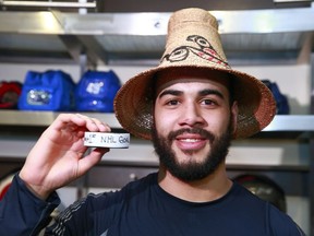 Darren Archibald shows off the puck he used to score his first — and so far only — NHL goal at Rogers Arena on March 8, 2014. (Photo: Jeff Vinnick, NHLI via Getty Images files)