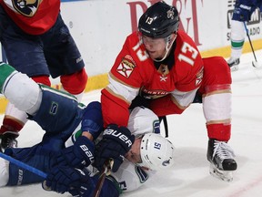 Mark Pysyk of the Florida Panthers takes Troy Stecher to the ice during second-period action at the BB&T Center on February 6, 2018 in Sunrise, Florida.