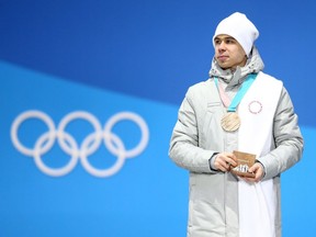 Semen Elistratov of Russia stands on the podium after winning bronze in the Men's Short Track 1500m on Sunday in Pyeongchang. The Olympic Athletes from Russia designation, which means athletes can't show their country's flag or hear its anthem, is a poor compromise on the part of the IOC, which should have banned the country entirely for its doping violations.