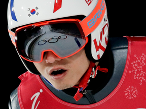 Seou Choi, of South Korea, soars through the air during training for the men's large hill individual ski jumping competition.