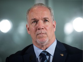 British Columbia Premier John Horgan listens during a news conference in Vancouver, B.C., on Friday February 2, 2018.