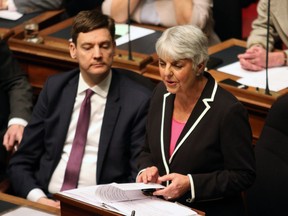 Attorney General David Eby looks on as Finance Minister Carole James delivers the budget speech from the legislative assembly at Legislature in Victoria, B.C., on Tuesday, February 20, 2018.
