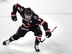 Northeastern forward Adam Gaudette (8) celebrates after his goal against Boston University goaltender Jake Oettinger, top, during the first period of the championship game of the Beanpot hockey tournament in Boston, Monday, Feb. 12, 2018.