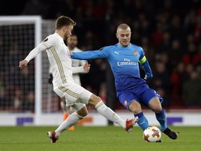 Arsenal's Jack Wilshere, right, battles for the ball with Ostersunds' Dennis Widgren during the Europa League Round of 32 at the Emirates Stadium in London, Thursday, Feb. 22, 2018.