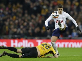 Tottenham's Erik Lamela, right, gets past Newport's Mickey Demetriou during the English FA Cup fourth-round replay soccer match between the Hotspur and Newport County at Wembley Stadium in London on Feb. 7, 2018.