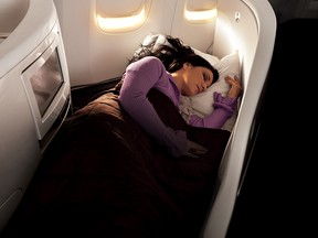 A woman sleeping in Business Premier class on Air New Zealand.