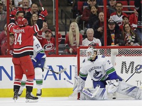 Carolina Hurricanes' Phillip Di Giuseppe (34) celebrates his goal against Vancouver Canucks goalie Jacob Markstrom during the first period of an NHL hockey game in Raleigh, N.C., Friday, Feb. 9, 2018.