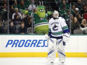 Dallas Stars mascot Victor E Green reacts to a call of no goal, after video review, by the Stars as Jacob Markstrom looks on.