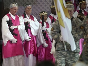 Men wear crowns and hold unloaded weapons at the World Peace and Unification Sanctuary, Wednesday Feb. 28, 2018 in Newfoundland, Pa.