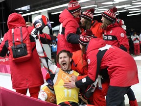 The Canadian luge team celebrates after their performance in the team relay competition, which would land them the silver medal, on Thursday, Feb. 15, 2018.