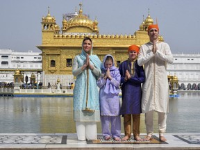 Justin Trudeau, right, his wife Sophie Gregoire Trudeau, left, their daughter Ella Grace, second left, and son Xavier greet in Indian style during their visit to Golden Temple, in Amritsar, India, Wednesday, Feb. 21, 2018.