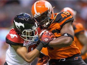 Though Rolly Lumbala is more about making holes for other runners, he does occasionally carry the ball, such as this play on June 17, 2016, battling Ciante Evans of the Calgary Stampeders.