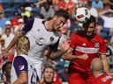 Jose Aja of Orlando City FC, left, heads the ball at the goal past Jonathan Campbell of the Chicago Fire during an MLS match in Chicago in 2016.