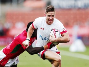 Luke McCloskey of Canada is tackled by a Kenyan opponent during the 2018 New Zealand Sevens at FMG Stadium on February 3, 2018 in Hamilton, New Zealand.