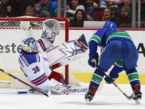 Brock Boeser scores his first of two goals on Henrik Lundqvist of the Rangers on Wednesday night.