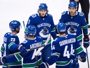 Vancouver Canucks' Alexander Edler, of Sweden, from left to right, Darren Archibald, Loui Eriksson, of Sweden, Erik Gudbranson and Brandon Sutter celebrate Archibald's goal against the Colorado Avalanche during the second period of an NHL hockey game in Vancouver, B.C., on Tuesday February 20, 2018.