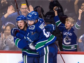 Brock Boeser gets a hug from Bo Horvat after scoring his 25th goal of the season Saturday.