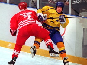 Canadian forward Todd Hlushko checks Swedish defenceman Magnus Svensson in the Lillehammer Olympic gold-medal game on Feb. 27, 1994.