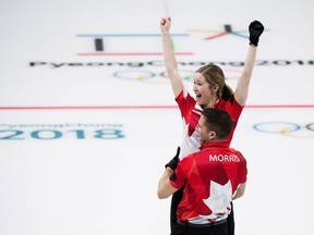 Canadians Kaitlyn Lawes and John Morris react after defeating Switzerland to win gold during mixed doubles curling action at the 2018 Olympic Winter Games in Gangneung, South Korea on Tuesday, February 13, 2018.