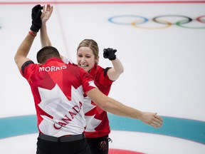 Canada's Kaitlyn Lawes and John Morris celebrate their gold-medal win against Switzerland in mixed doubles on Feb. 13.