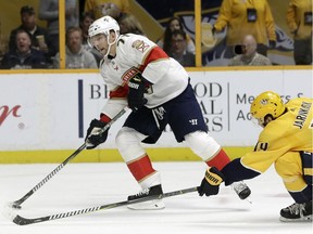 Predators centre Calle Jarnkrok, right, tries to slow down Florida Panthers right-winger Radim Vrbata during an NHL game Jan. 20 in Nashville, Tenn.