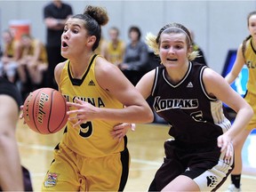 Kelowna's Taya Hanson calls the play in front of Heritage Woods' Maddy Counsell during the B.C. AAA High School Basketball Championship at the Langley Events Centre on Wednesday.