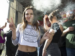 Joint toss members show how it's done as hundreds took part in the annual "420 celebration" and smoke up in front of Sunset beach in Vancouver on April 20, 2017.