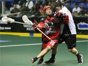 Curtis Hodgson, right, who played 13 seasons in the National Lacrosse League, will have his jersey retired on Saturday by the Vancouver Stealth at Langley Events Centre. Hodgson, a vice-principal at Burnaby South Secondary, checks Shawn Evans of the Calgary Roughnecks in NLL action.