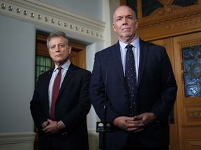 Premier John Horgan and Minister of Environment and Climate Change Strategy George Heyman answer questions about the Alberta dispute during a press conference Wednesday at the legislature in Victoria.
