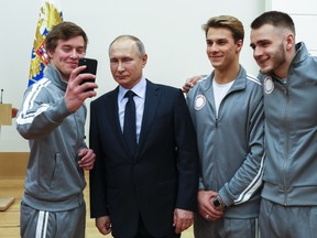 Russian Olympians take a selfie with Vladimir Putin in Moscow on Jan. 31.