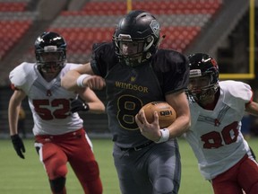 Windsor's Ryan Baker carries the ball against the Abbotsford Panthers during the B.C. High School AA football championship game in December.