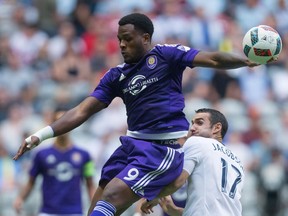 Orlando City's Cyle Larin, left, and Vancouver Whitecaps' Andrew Jacobson vie for the ball during the first half of an MLS soccer game in Vancouver on July 16, 2016. Orlando City has agreed to transfer Canadian striker Cyle Larin to Turkey's Besiktas, but not without a parting shot. The two clubs had been in a tug of war over the 22-year-old from Brampton, Ont., with Orlando insisting he was still under contract to the MLS team. The Turkish champions pushed ahead anyway, bringing Larin over to Istanbul.