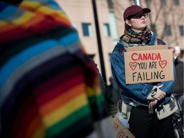 A woman holds a sign while listening during a rally for Tina Fontaine in Vancouver, B.C., on Saturday February 24, 2018. A man accused of killing a 15-year-old Indigenous girl and dumping her body in Winnipeg's Red River was found not guilty of second-degree murder this week.Tina Fontaine's remains were discovered eight days after she was reported missing in August 2014.