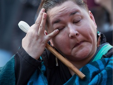 An Indigenous woman wipes away tears during a rally for Tina Fontaine in Vancouver, B.C., on Saturday February 24, 2018. A man accused of killing a 15-year-old Indigenous girl and dumping her body in Winnipeg's Red River was found not guilty of second-degree murder this week.Tina Fontaine's remains were discovered eight days after she was reported missing in August 2014.