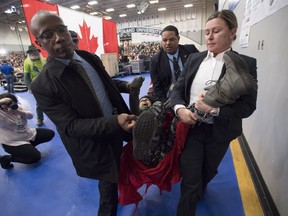 A protester is carried out of the building by police officers during a public town hall with Prime Minister Justin Trudeau in Nanaimo last week.