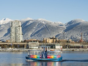 VANCOUVER,BC:DECEMBER 6, 2016 -- An Aquabus makes its way through the waters of False Creek with the snow caped North Shore Mountains providing a backdrop to the morning ride in Vancouver, BC, at day break, December, 6, 2016. (Richard Lam/PNG) (For ) [PNG Merlin Archive]
