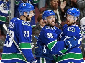 Sam Gagner is greeted by Daniel Sedin, right, and Alex Edler after scoring March 27 against Anaheim.