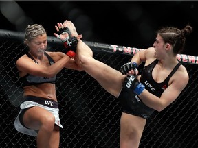Ashley Yoder, left, blocks a kick from Mackenzie Dern during their women's strawweight bout during UFC 222 at T-Mobile Arena on March 3, 2018 in Las Vegas, Nevada. Dern won by split decision.