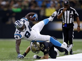 Tight end Ed Dickson #84 of the Carolina Panthers is tackled by A.J. Klein #53 of the New Orleans Saints during the first half of a game at the Mercedes-Benz Superdome on Dec. 3, 2017, in New Orleans. Dickson has been signed by the Seattle Seahawks to a three-year deal.