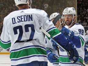 Sam Gagner of the Vancouver Canucks celebrates a goal against the Toronto Maple Leafs with Daniel Sedin. Gagner seems poised to start Saturday's game on the same line as the twins.