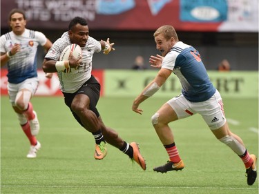France 7's (blue & white) vs Fiji 7's (white) vie in the HSBC Canada Men's Sevens at BC Place Stadium in Vancouver, on March 10, 2018.