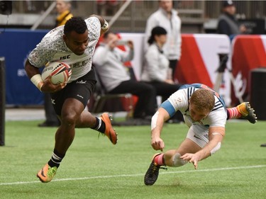 France 7's (blue& white) vs Fiji 7's (white) vie in the HSBC Canada Men's Sevens at BC Place Stadium in Vancouver, on March 10, 2018.