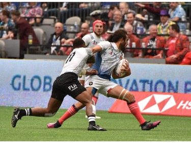 France 7's (blue & white) vs Fiji 7's(white) vie in the HSBC Canada Men's Sevens at BC Place Stadium in Vancouver, on March 10, 2018.