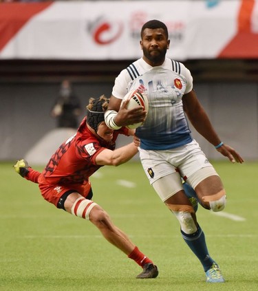 France 7's (9)Tavite Veredamu, (blue &white) runs the ball with Wales's 7's (10) Cai Devine in pursuit in HSBC Canada Men's Sevens action at BC Place Stadium in Vancouver, British Columbia on March 11, 2018. Vancouver is the 6th round, played March 10-11, 2018, in the HSBC Men's Sevens 10 round world series.