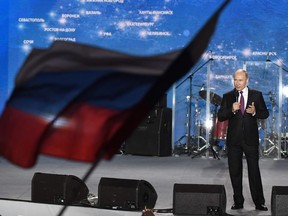 Russian President Vladimir Putin addresses supporters during a rally celebrating the fourth anniversary of Russia's annexation of Crimea at Sevastopol's Nakhimov Square on March 14, 2018.