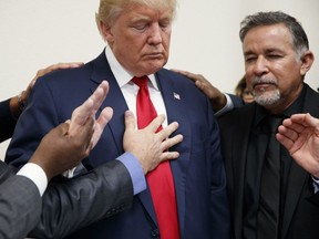 Pastors from the Las Vegas area pray with Donald Trump during a visit in 2016.