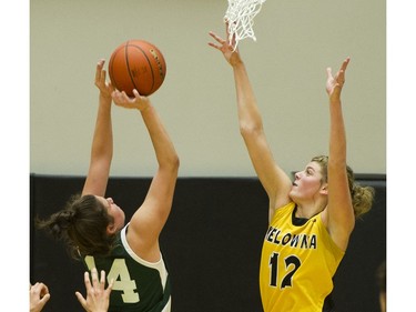 LANGLEY. March 03 2018..   Kelowna Owls #12 Kennedy Dickie defends against Walnut Grove Gators #14 Natalie Rathler as she shoots in the final of the AAA Girls High School Basketball final at LEC, Langley, March 03 2018.   Gerry Kahrmann  /  PNG staff photo)( For Prov / Sun News )   00052469A Story by Steve Ewen [PNG Merlin Archive]