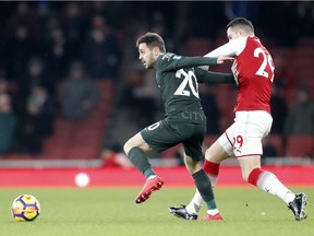 Manchester City's Bernardo Silva, left, is challenged by Arsenal's Granit Xhaka during this week's English Premier League match at the Emirates stadium in London.