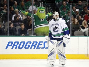 The Dallas Stars' mascot, Victor E Green, shouts at Vancouver Canucks' goaltender Jacob Markstrom during an NHL game in Dallas on Feb. 11, 2018.